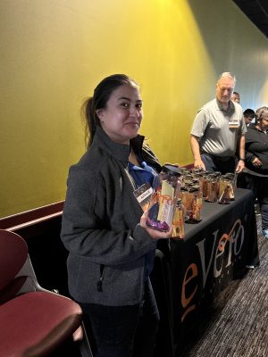 eVero staff holding water bottles by table