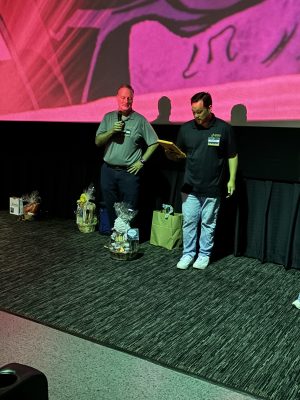 eVero staff in front of theater screen
